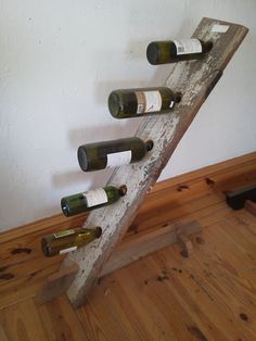 a wooden wine rack with six bottles on it