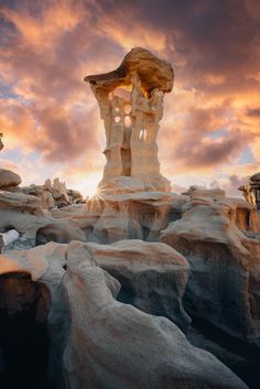 the sun is setting over some rocks and rock formations in an area that looks like it's been carved out of ice