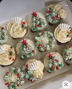 twelve cupcakes decorated with white frosting and christmas decorations