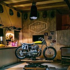 a motorcycle is on display in a shop with other motorcycles and accessories around the room