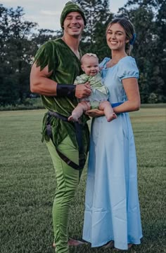 a man and woman dressed up as peter panton and princess leia, holding a baby