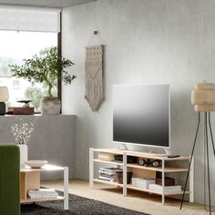 a flat screen tv sitting on top of a wooden stand