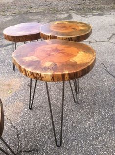 three wooden tables sitting on top of cement ground