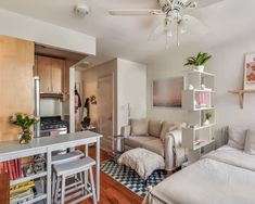 a living room filled with furniture next to a kitchen