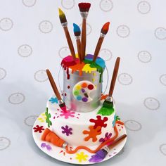 there is a cake with paintbrushes on it