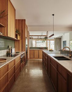 a kitchen with wooden cabinets and white counter tops