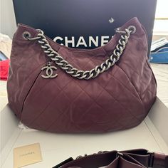 Chanel Burgundy Bag. Full Set. Card # Starts In 17 (2012). Purchased From Saks. This Is Slouchy And It Was Challenging To Capture Her Beauty. The Chain Is Antique Silver Tone But Not Heavy. Leather Is Soft, Some Creasing In Front And Back, Prominent On Corner Of The Bag, Likely From It Being Non Structured (Stored Flat With Inserts), No Peeling, No Significant Scratches, Trim On Edge Looks Good With Minimal Scratches (Very Small). Quilting Stitches Intact, I Did Not See Any Loose Ones, Spacious Interior With Zipped Pocket Inside And Small Open Pockets On The Other Side, 18”X12”, Detachable, Adjustable Wide Strap (Comfortable On Shoulder). Strap Has Indentation Where I’ve Move Quilting Stitches, Burgundy Bag, Chanel Handbags, Grey Fabric, Wide Straps, The Other Side, Full Set, Chanel Bag, Inside Pocket