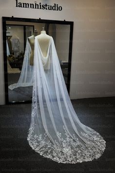 a white wedding veil on display in front of a mirror