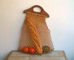 a bag that is sitting on top of a wooden table next to some fruit and vegetables