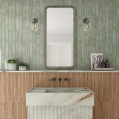 a white sink sitting under a mirror next to a wooden cabinet and wall mounted faucet