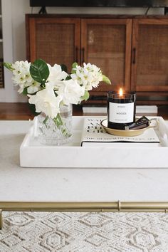 a tray with flowers and a candle on it