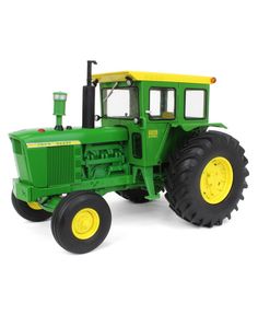 a green toy tractor on a white background