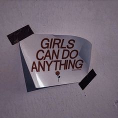 a piece of paper with the words girls can do anything written on it, pinned to a wall