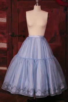 a mannequin wearing a light blue skirt