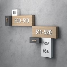 two wooden signs mounted to the side of a wall next to each other with numbers on them