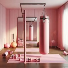 there is a pink room with two boxing bags on the floor and other accessories around it