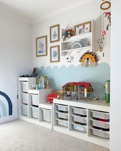 a child's playroom with toys and storage bins