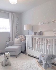 a baby's room with a crib, rocking chair and stuffed animals