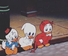 three cartoon characters sitting on the ground next to a trash can, one with an orange nose