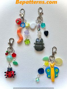 a group of different key chains with charms attached to them on top of a white surface