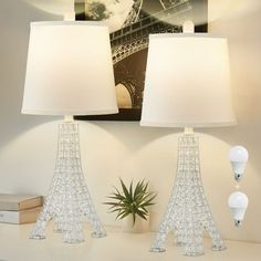 two lamps sitting on top of a white table