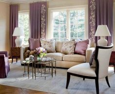 a living room filled with furniture and purple curtains