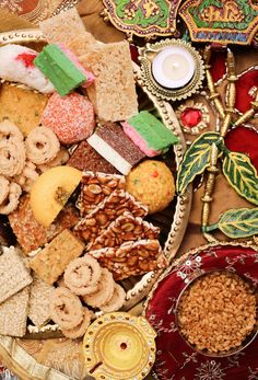 a plate full of assorted cookies, crackers, and other snacks on a table