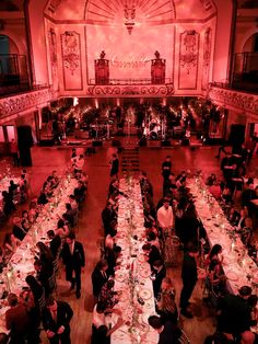 an overhead view of a banquet hall with long tables and people sitting at the tables