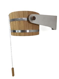 a wooden barrel with chains hanging from it's side and a metal hook attached to the outside