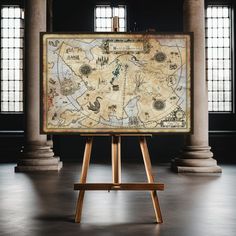 an old map is on display in the middle of a room with columns and windows