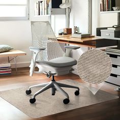 an office chair sitting on top of a rug in front of a desk and bookshelf