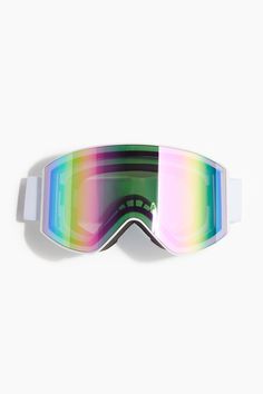 a pair of ski goggles sitting on top of a white wall