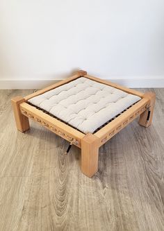 a wooden frame with a mattress on it