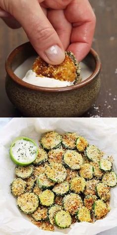 someone is dipping something into a bowl with cucumber slices on it and another hand holding a small piece of bread