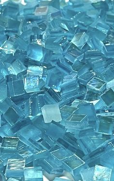 a pile of blue glass tiles sitting on top of a table