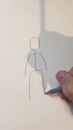 someone is drawing a man with a pencil