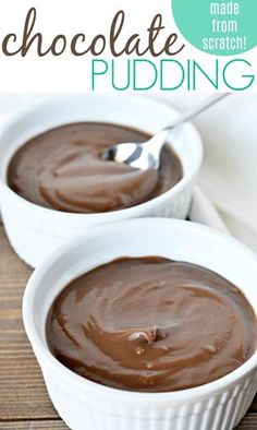 two white bowls filled with chocolate pudding on top of a wooden table