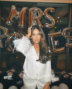 a woman standing in front of some balloons