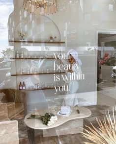 there is a display in the window of a beauty shop that has flowers on it