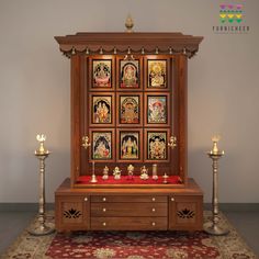 a wooden cabinet with pictures on the wall and candles in front of it, sitting on a rug