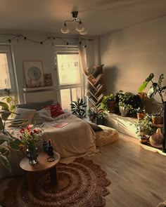 a bed room with a neatly made bed and lots of plants