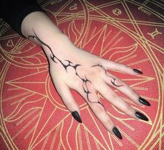 a woman's hand with black ink on it