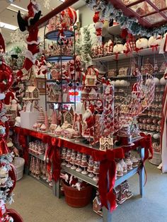 a store filled with lots of red and white christmas decorations