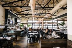 people are sitting at tables in a restaurant