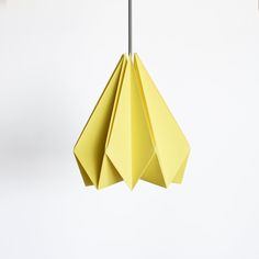 a yellow origami hanging from a ceiling