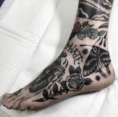 a tattoo on the foot of a person with flowers and butterflies all over their body