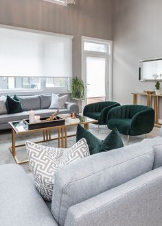 a living room with couches, chairs and coffee table in it's center