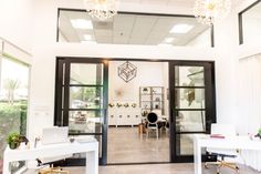 an office with two desks and chairs in front of glass doors that lead to the outside