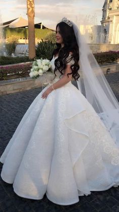 a woman wearing a wedding dress and veil