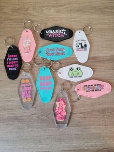 six key chains with different sayings on them sitting on a table next to each other